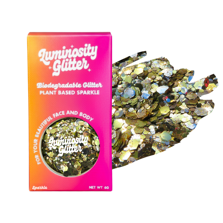 Luminosity Glitter packaging with biodegradable and plant-based sparkle, next to a handful of glitter on a white background.