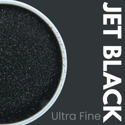 Ultra fine jet black glitter powder in a container with 'JET BLACK Ultra Fine' text on a dark background