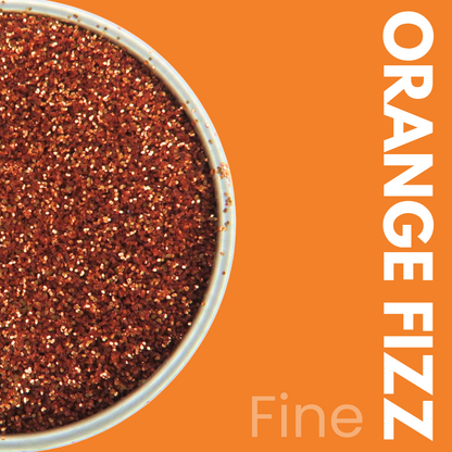Container of orange glitter with 'Orange Fizz' text on an orange background