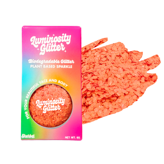 Luminosity Glitter packaging with coral glitter on a white background