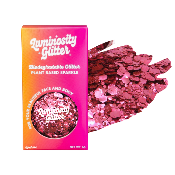 Luminosity Glitter packaging with pink glitter on a white background