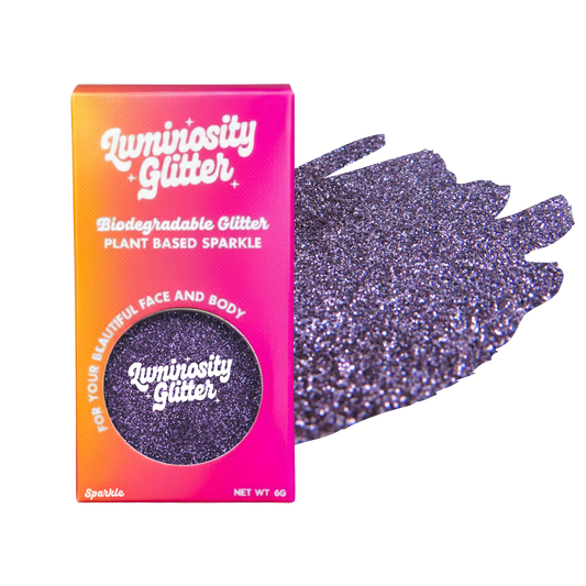 Luminosity Glitter packaging with purple glittery gloves on a white background