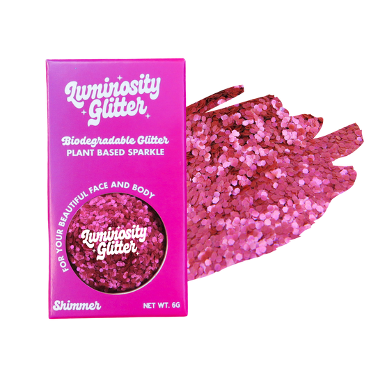 Pink glitter packaging with a sample of pink glitter on a white background