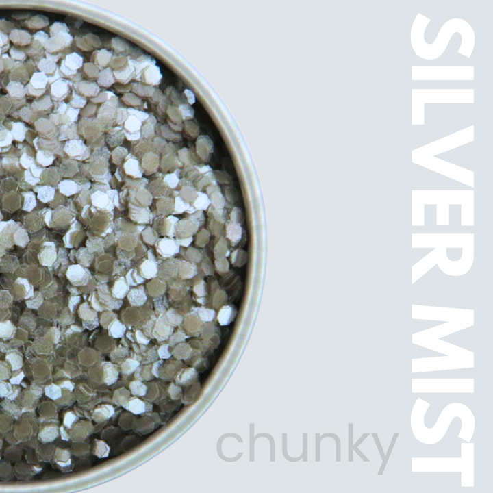 Silver mist chunky nail art powder in a container with &