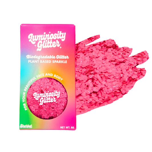 Luminosity Glitter packaging with pink glitter on a white background