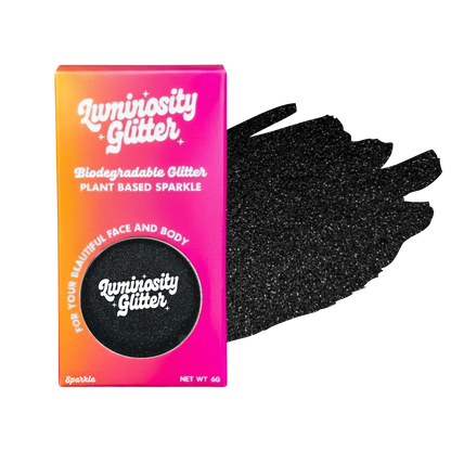 Luminosity Glitter packaging with black glittery hand for face and body use