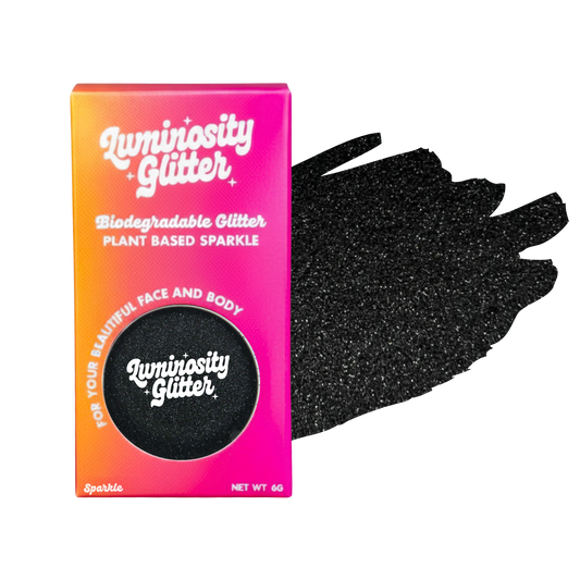Luminosity Glitter packaging with black glittery hand for face and body use