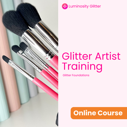 Makeup brushes with pink handles and black bristles, Luminosity Glitter branding on a white background.
