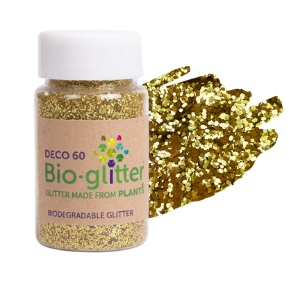A bottle of chunky craft Bio-glitter DEC0 60 biodegradable glitter with a white cap and a kraft paper label, shown next to a textured swatch of gold glitter on a white background.