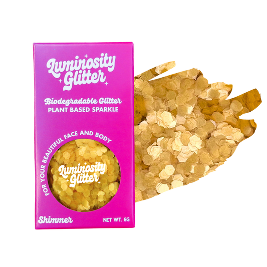 Luminosity Glitter packaging with gold glitter on a white background