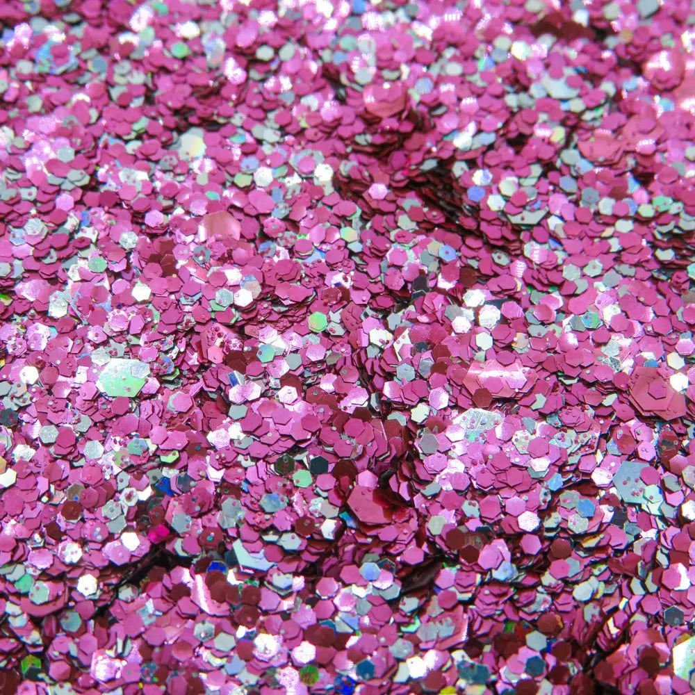 Close up of pink flamingo eco friendly glitter blend for use on your face, body, hair and nails.