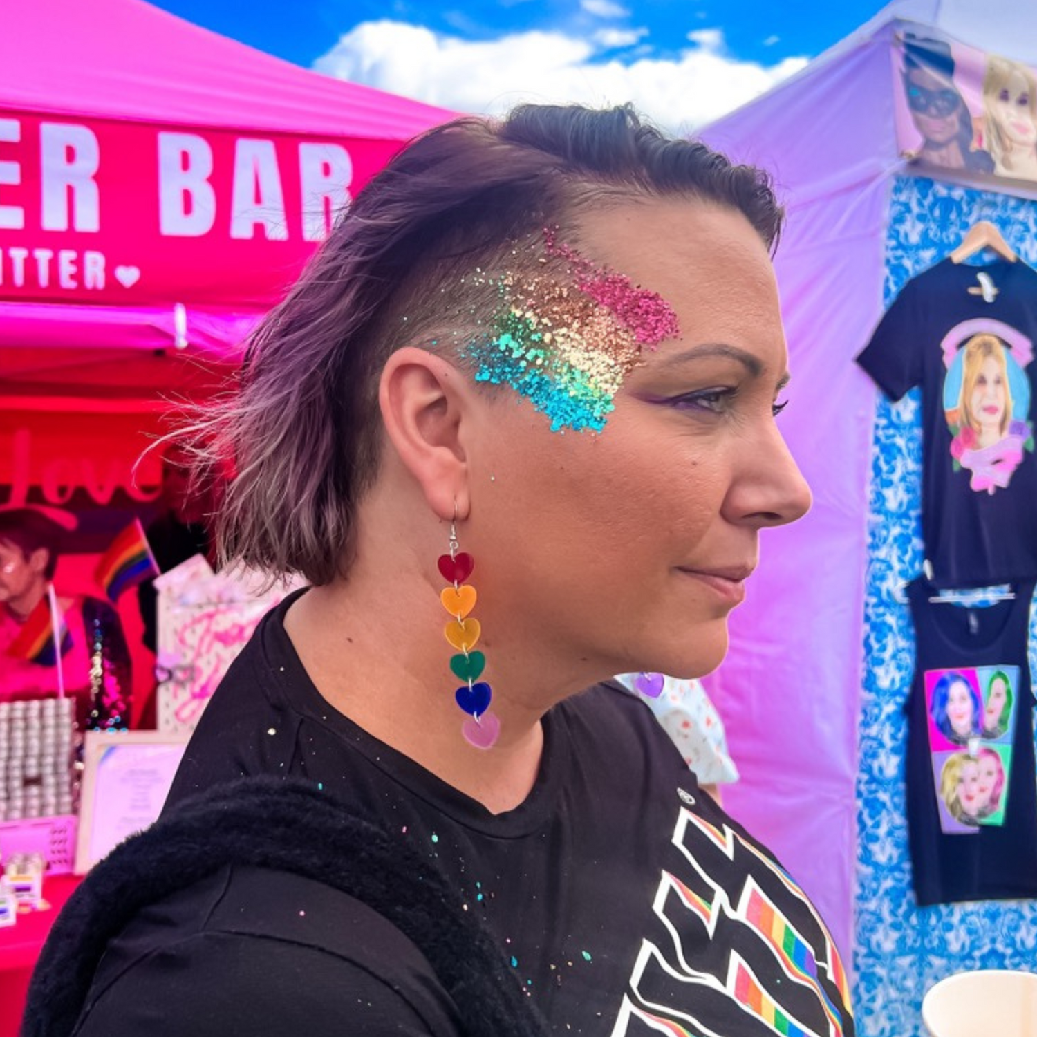 Rainbow hair and face glitter for pride celebrations.