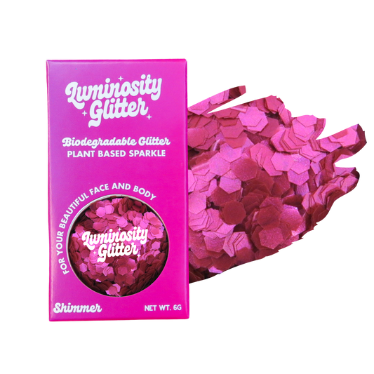 Pink glitter packaging with 'Luminosity Glitter' branding on a white background