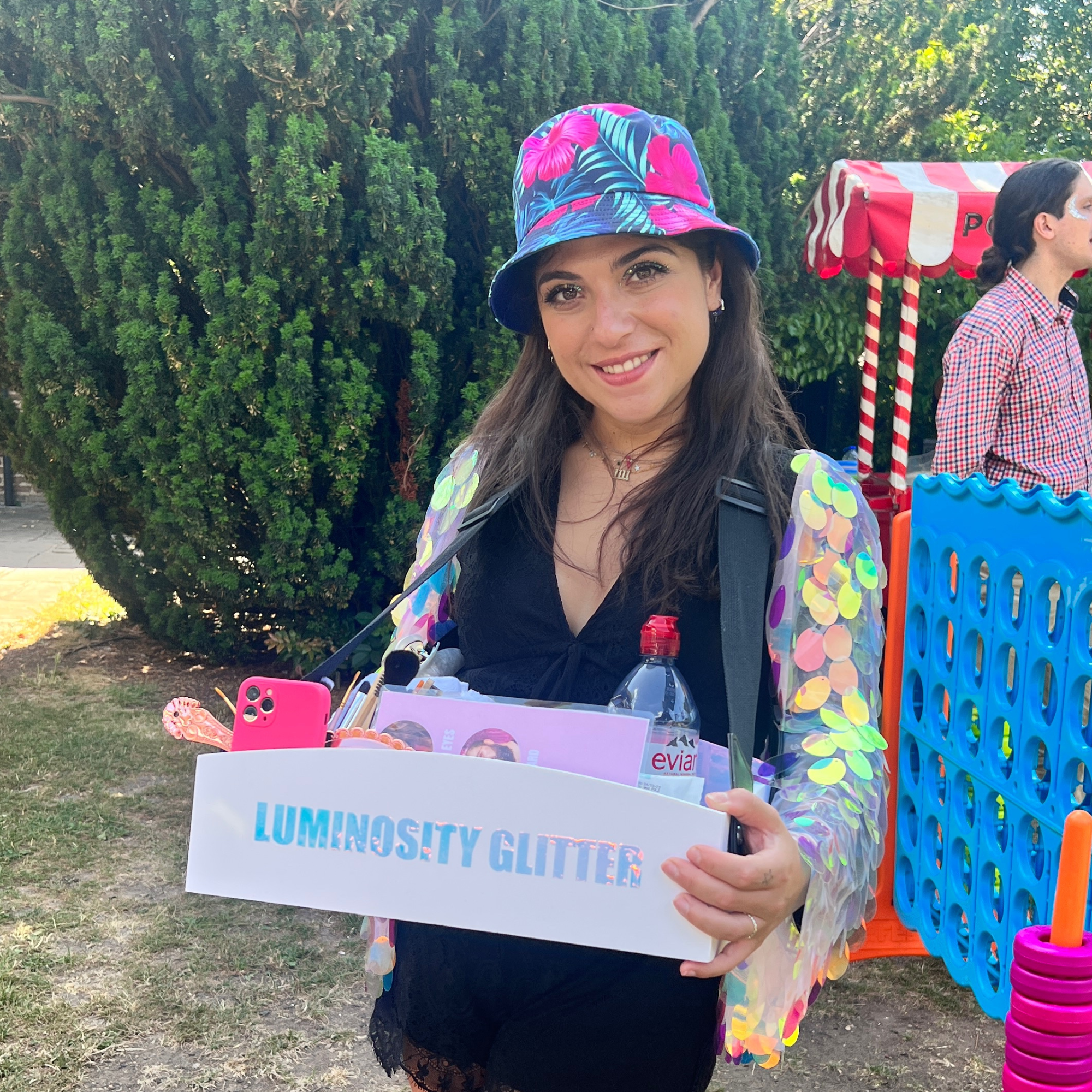 Roaming glitter artist applying glitter at a party
